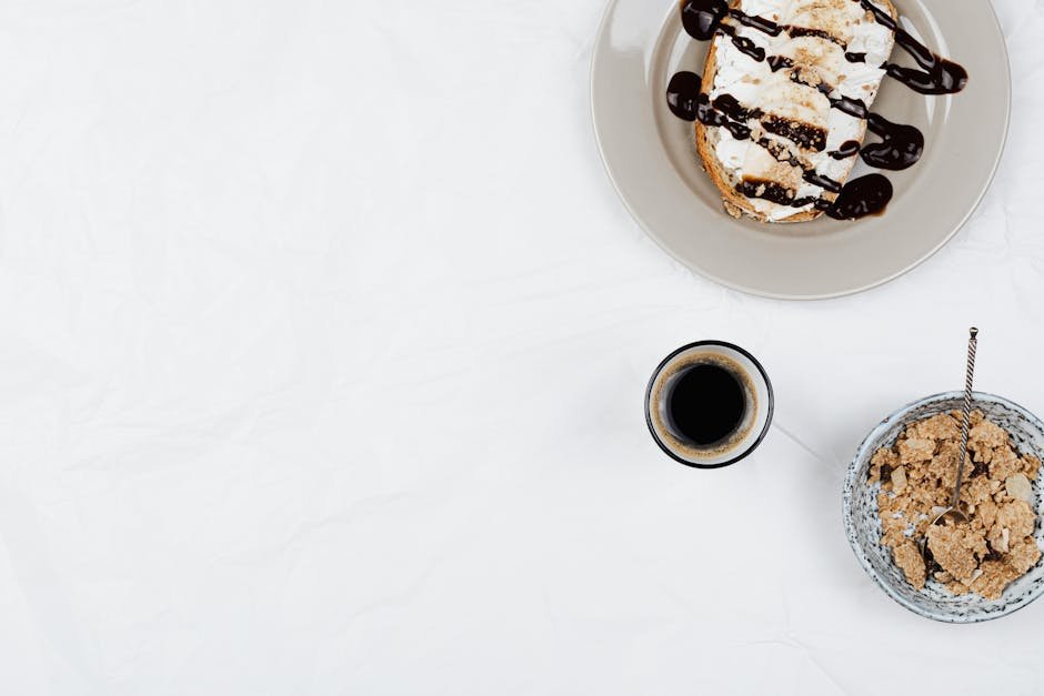 Top view of a breakfast setup with coffee, pastries, and cornflakes on white background.