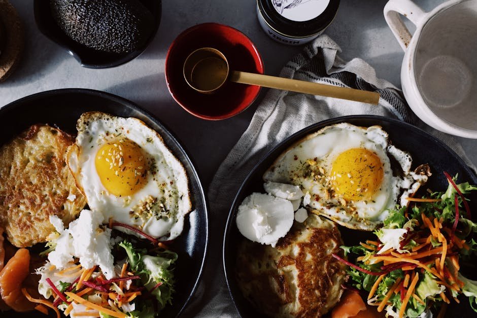 A delicious breakfast featuring fried eggs, fresh salad, and toast on a plate.