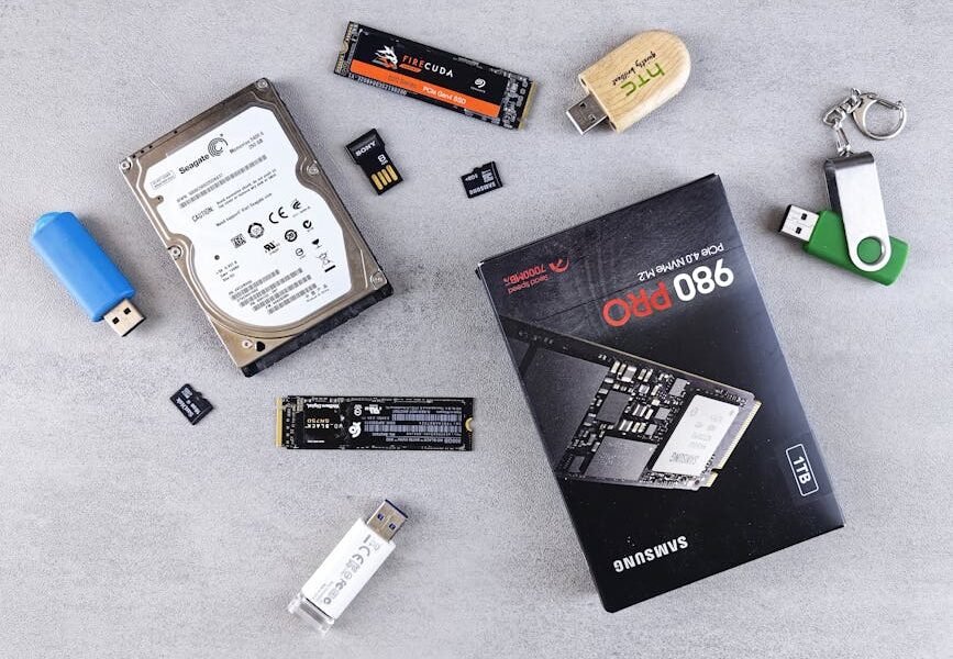 Flat lay of various computer data storage devices on a gray surface.